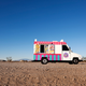 Small food truck crossing desert horizon